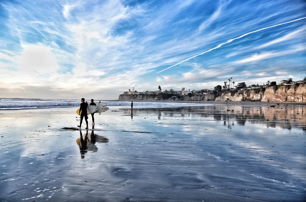 Del Mar sunset at the beach of san diego with surfers